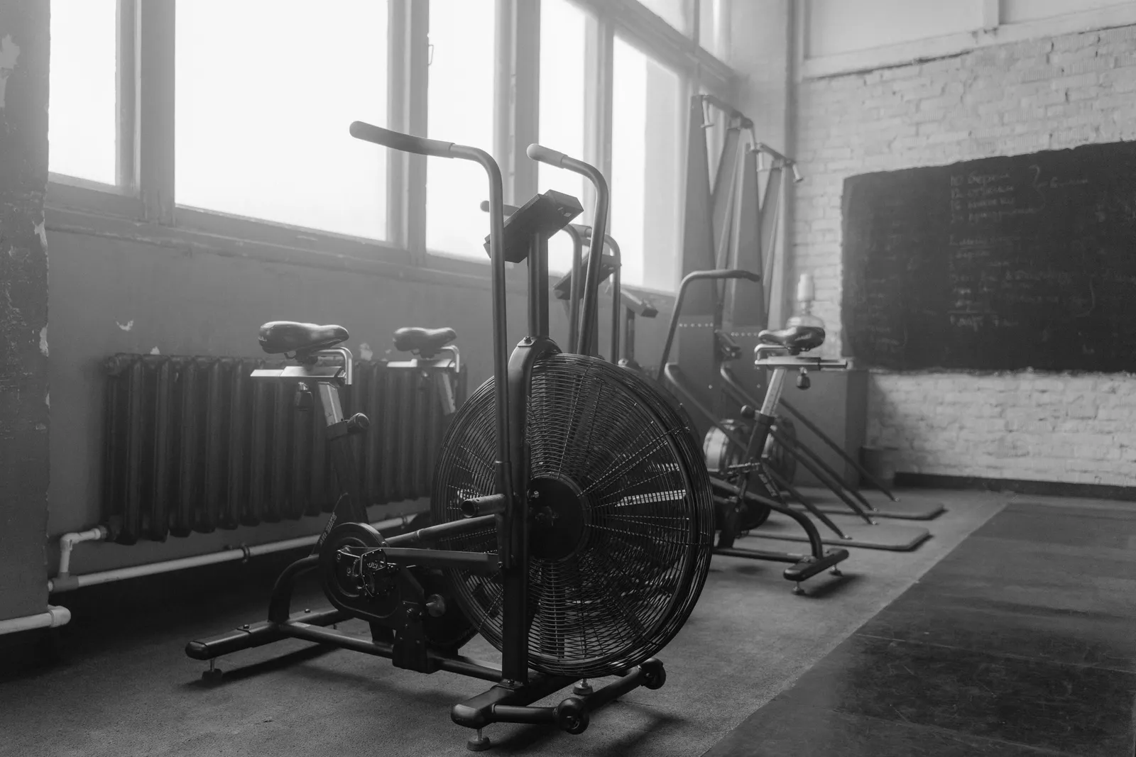 Monochrome indoor exercise bikes in a gym